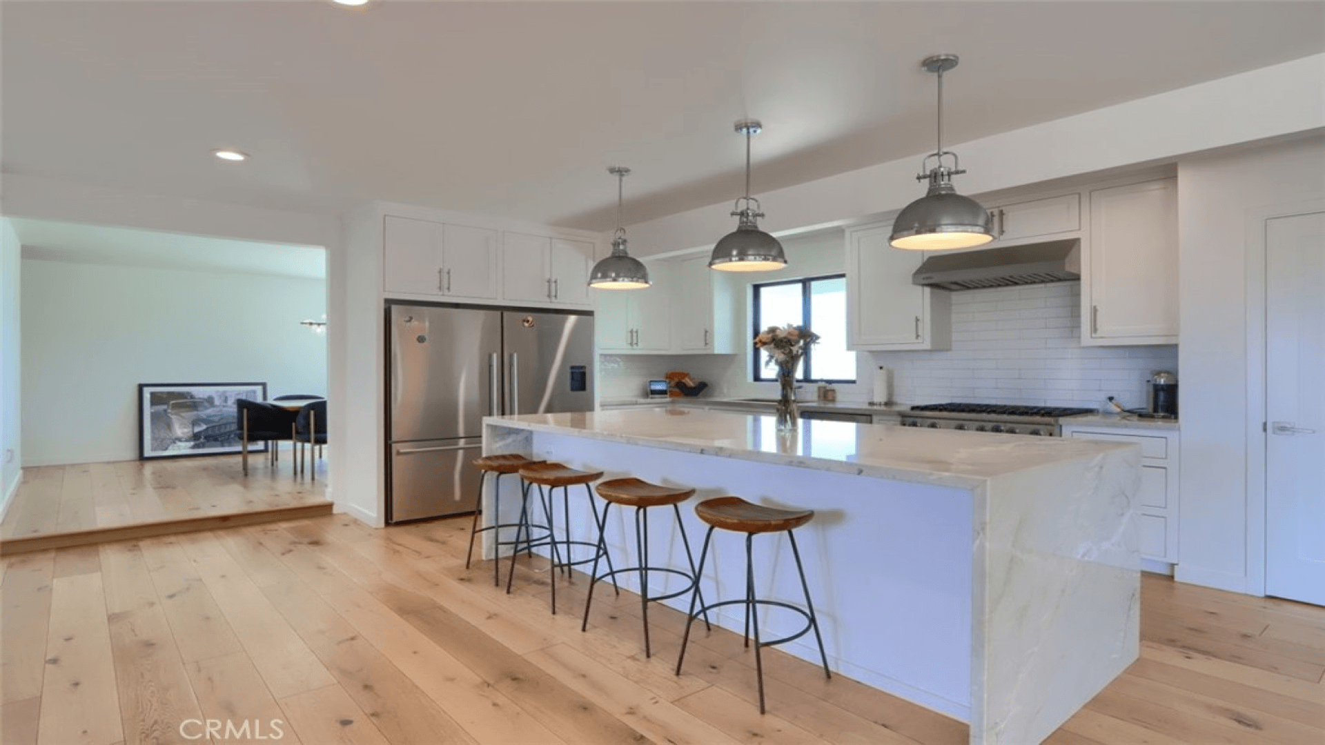 Modern kitchen with white island and pendant lights
