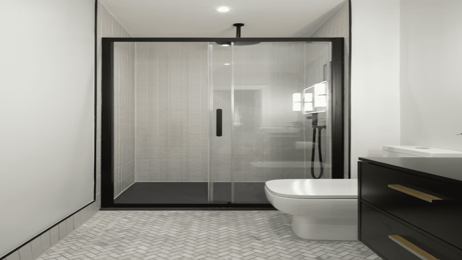 Modern primary bathroom with glass shower and herringbone tile